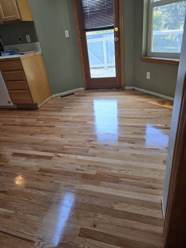 Refinished hardwood floor in kitchen of Bothell home